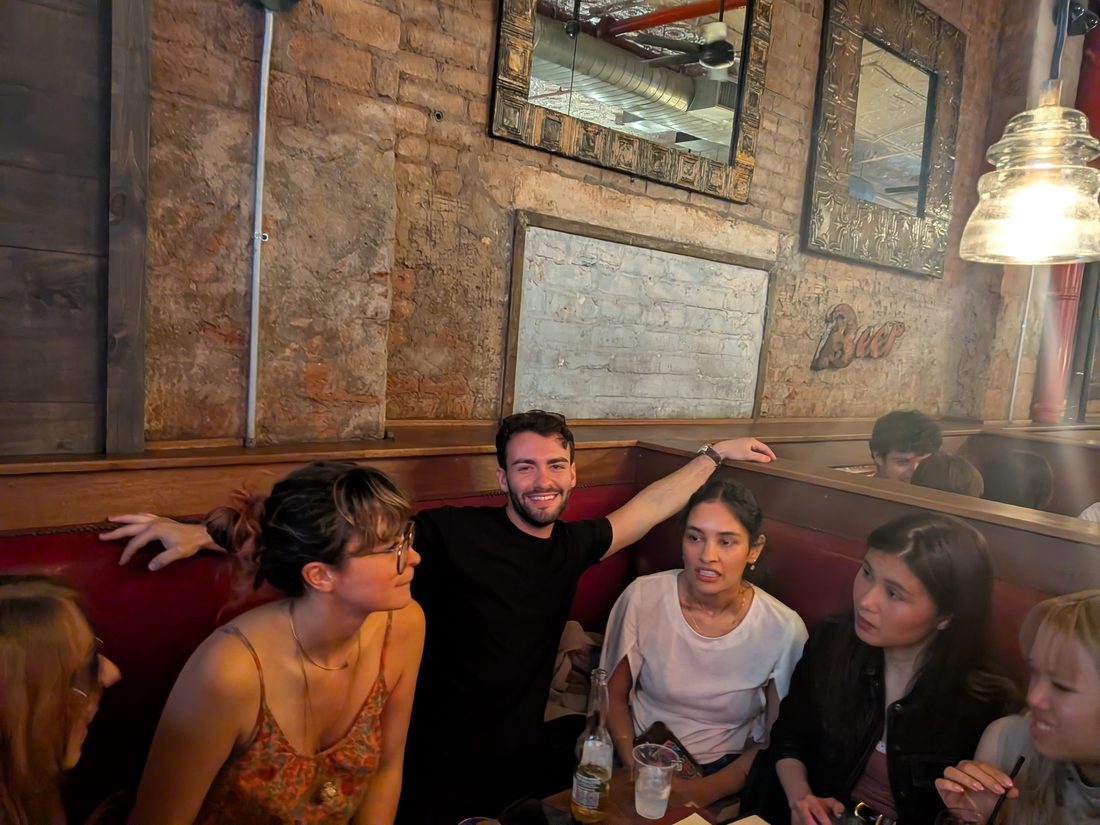 The crew squeezed into a booth at a bar