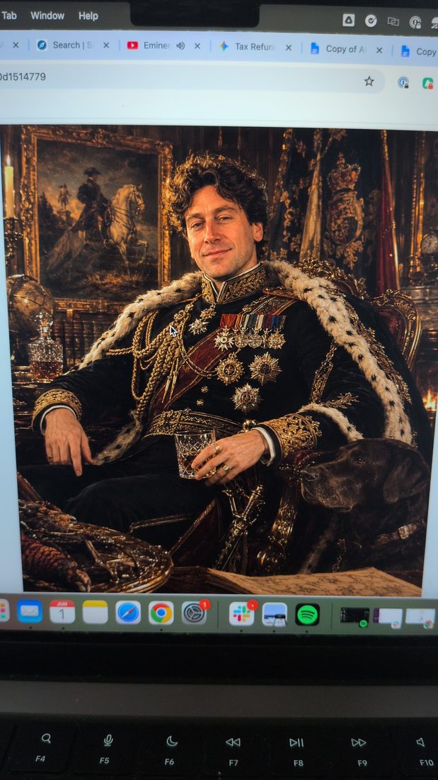An ornate royal portrait displayed on a laptop screen